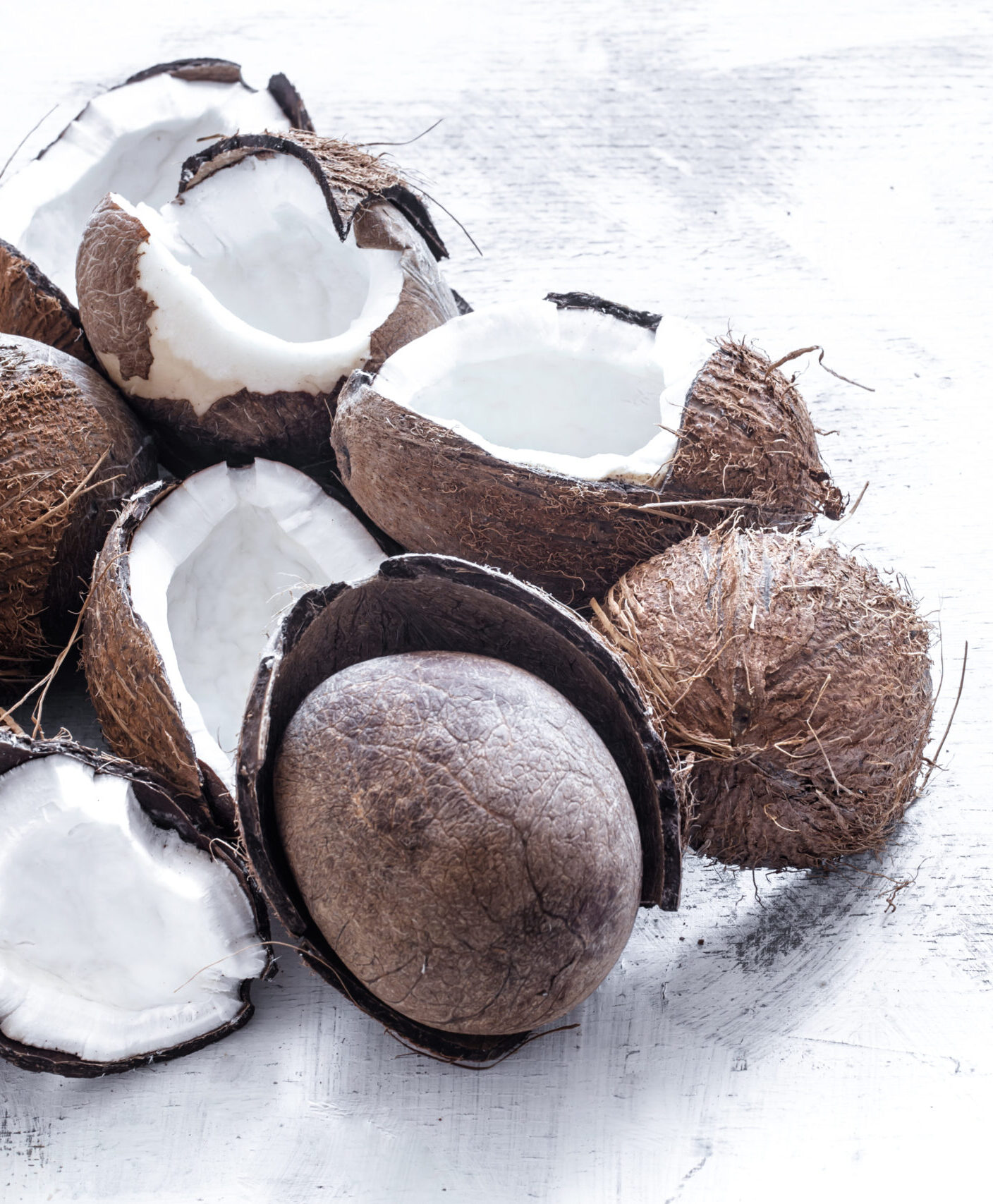 Tropical fruit halved rozbitogo coconut on a light background, the concept of organic fruit